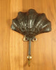 antique finishing brass sea shell wall hook on wooden surface
