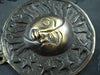 Close up of antique brass sun moon wall hook texture, vintage celestial hardware detail