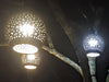 Artisan hand carving coconut shell lamp shade in Bali workshop