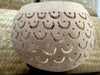 Beige fish scale carved coconut shell planter close-up