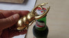 Brass beetle bottle opener on woven texture, styled decor-friendly bar tool