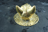Top view of the brass cat head showing the pointed ears and the depth of the hand-cast head above the ornate round plate. Real photo of a handmade brass towel ring and gothic door knocker, cast from recycled brass in Ubud, Bali.