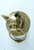 Unedited side view of the brass cat head towel ring on a light background, showing the depth of the sculpted head, the pointed ears and the solid ring. A genuine handmade brass door knocker and drawer pull from Ubud, Bali.