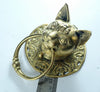 Brass cat head towel ring photographed beside a ruler to show its true size, with the cat's head, ears and brass ring in profile. A handmade antique-style towel ring and gothic door knocker, hand-cast from recycled brass in Bali.