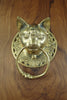 Front view of the brass cat towel ring on a light wooden surface, showing the detailed cat face, ornate Victorian scrollwork and solid ring in polished gold. A handmade hand towel holder and cat lover gift from Bali.