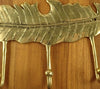 brass-feather-hook-rack-3-hooks-on-wood-front