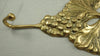 Bottom angle of brass grape wall hook, vintage towel hook detail, decorative wall hook for farmhouse decor