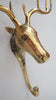 Real close-up photo of the brass moose head mounted on a light wall, showing the hand-finished face, ear and eye detail in polished brass. A handmade moose wall hook and moose lover gift, cast by artisans in Bali.