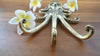 Brass octopus wall hook placed on table kraken decor styling product photo