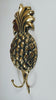 Angled side profile view of brass pineapple double wall hook showing full hook length pineapple body detail and antique gold patina finish – pineapple hook brass pineapple wall hook – tropical boho beach house coastal home decor – coat hook towel hook – made in Bali