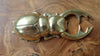 gold finish scarab bug bottle opener on a wooden surface