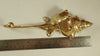 Brass shell spiral hook shown next to a ruler for size reference