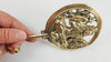 Hand holding solid brass Lord Shiva wall hook from the side showing disc depth mounting hardware and curved hook from behind — om wall hook Hindu spiritual decor hand cast brass ethically made by Balinese Hindu artisans Bali