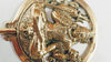 Close-up angled view of solid brass Lord Shiva wall hook showing intricate hand-cast Shiva figure facial features seated meditation pose trident and circular disc ornamentation — Hindu home decor spiritual yoga room decor ethically handmade by Balinese Hindu artisans Ubud Bali