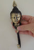 Buddha wall hook held in hand for scale, solid brass spiritual decor piece