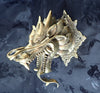 Front-facing brass dragon head wall decor on dark background, dark academia aesthetic