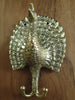Side view of brass peacock double hook showing depth from wall