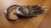 Antique brass hamsa hand door knocker resting on wooden surface showing finish texture
