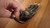 Antique finish hamsa hand door knocker shown in hand for realistic size reference