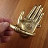 Side angle of gold brass hamsa hand door knocker highlighting ring handle and depth