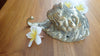 Brass lion wall hook laying flat showing profile and hook shape