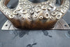 Base close-up of octopus tentacle door pull in antique finish with mounting plate