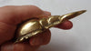 Side view of brass scarab beetle bottle opener showing hook opening edge