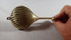 Side angle of brass seashell wall hook showing nautical shape and vintage finish