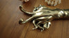 Brass squid wall hook placed on wooden surface showing natural coastal decor style